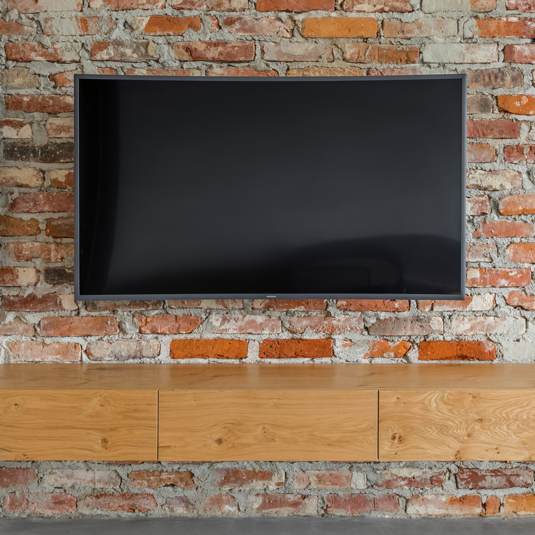 Tv screen on brick wall