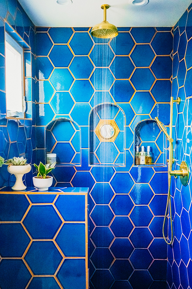 hexagon shaped blue shower tile in bohemian bathroom