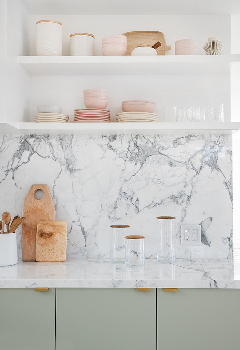 marble kitchen backsplash with open shelving and green cabinets