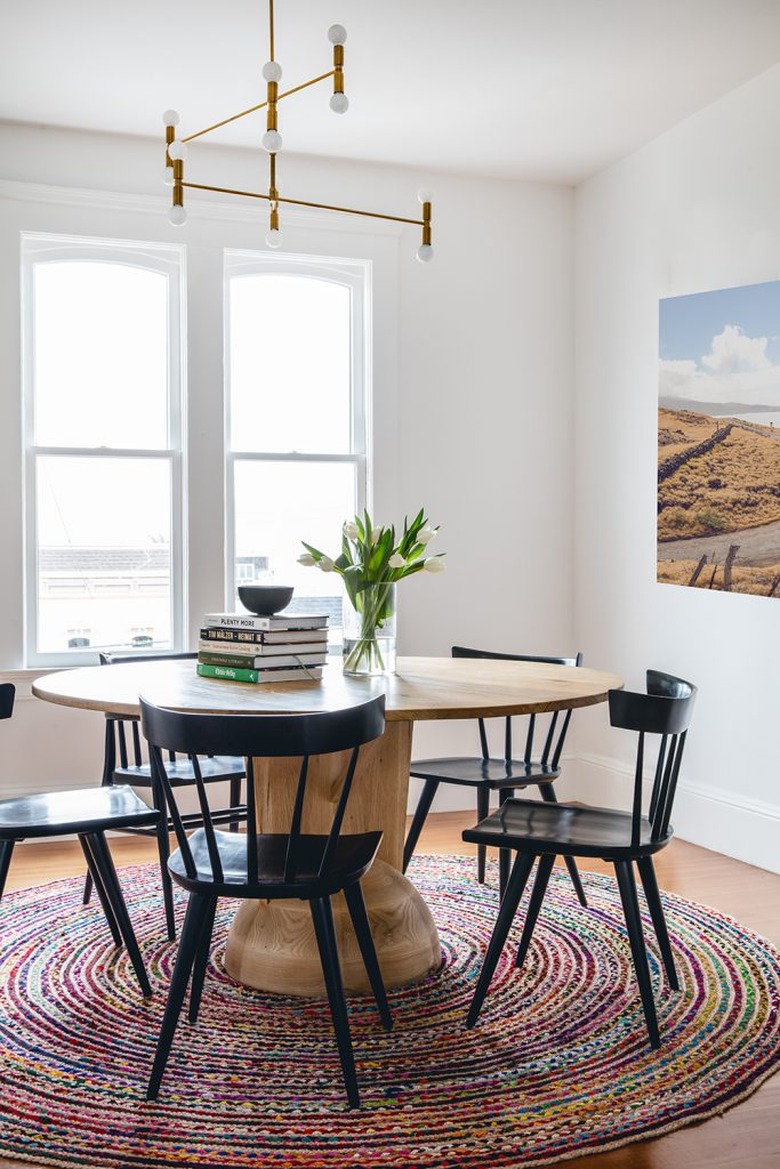 dining room design idea with round table and rug is used to define space