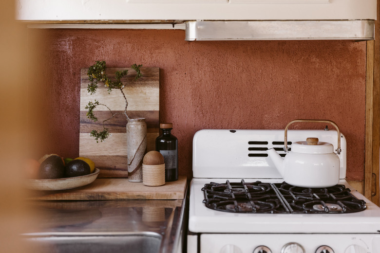 close up of small stove, kitchen knickknacks and teapot