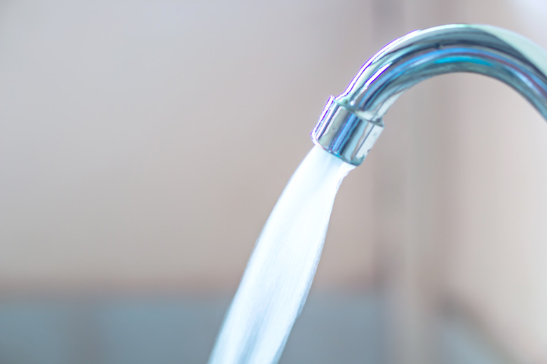 closeup water running from faucet