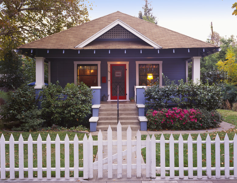 Small craftsman bungalow with picket fence.