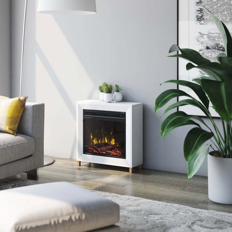 A white portable electric fireplace in a gray living room