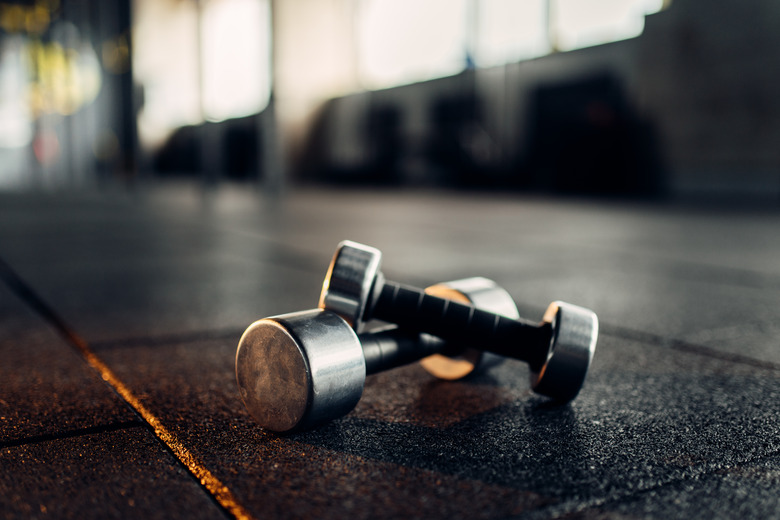 Dumbbells on rubber floor closeup, fitness club