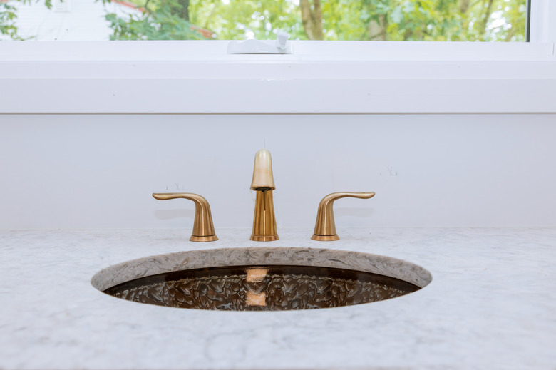 Close up of sinks in modern bathroom white stone