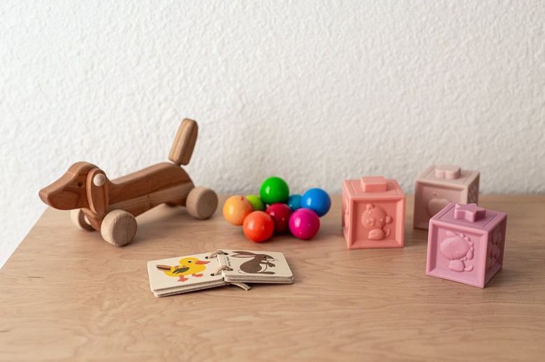 A wood dresser with toys, building blocks, and children