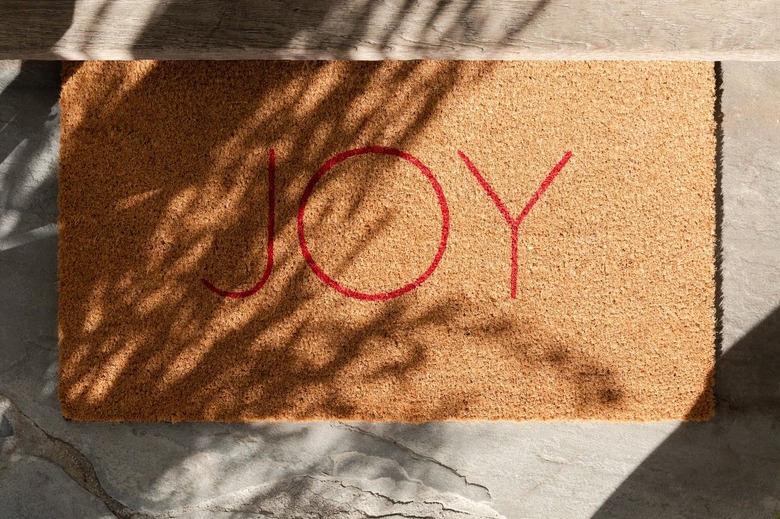 outdoor christmas doormat that says "Joy"