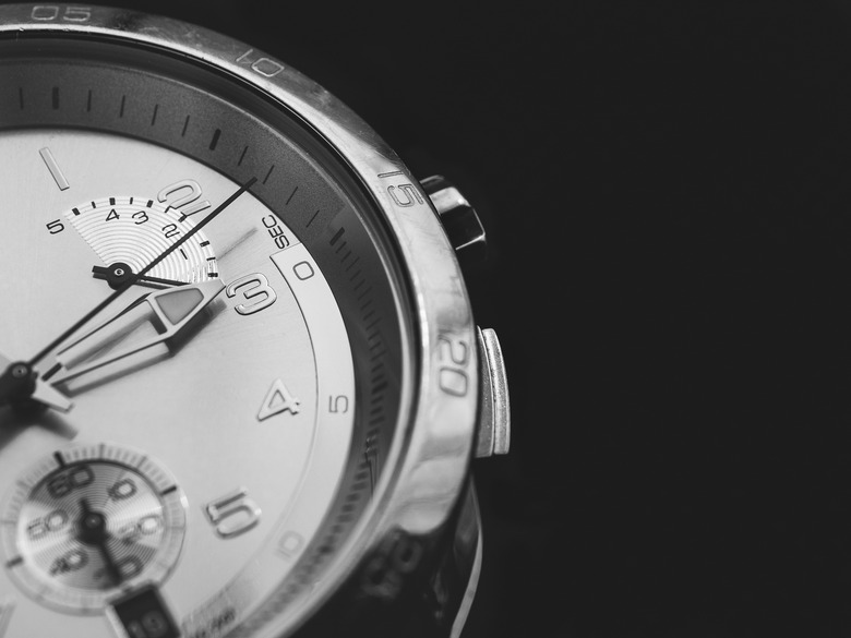 Man watches detail, closeup, dark background