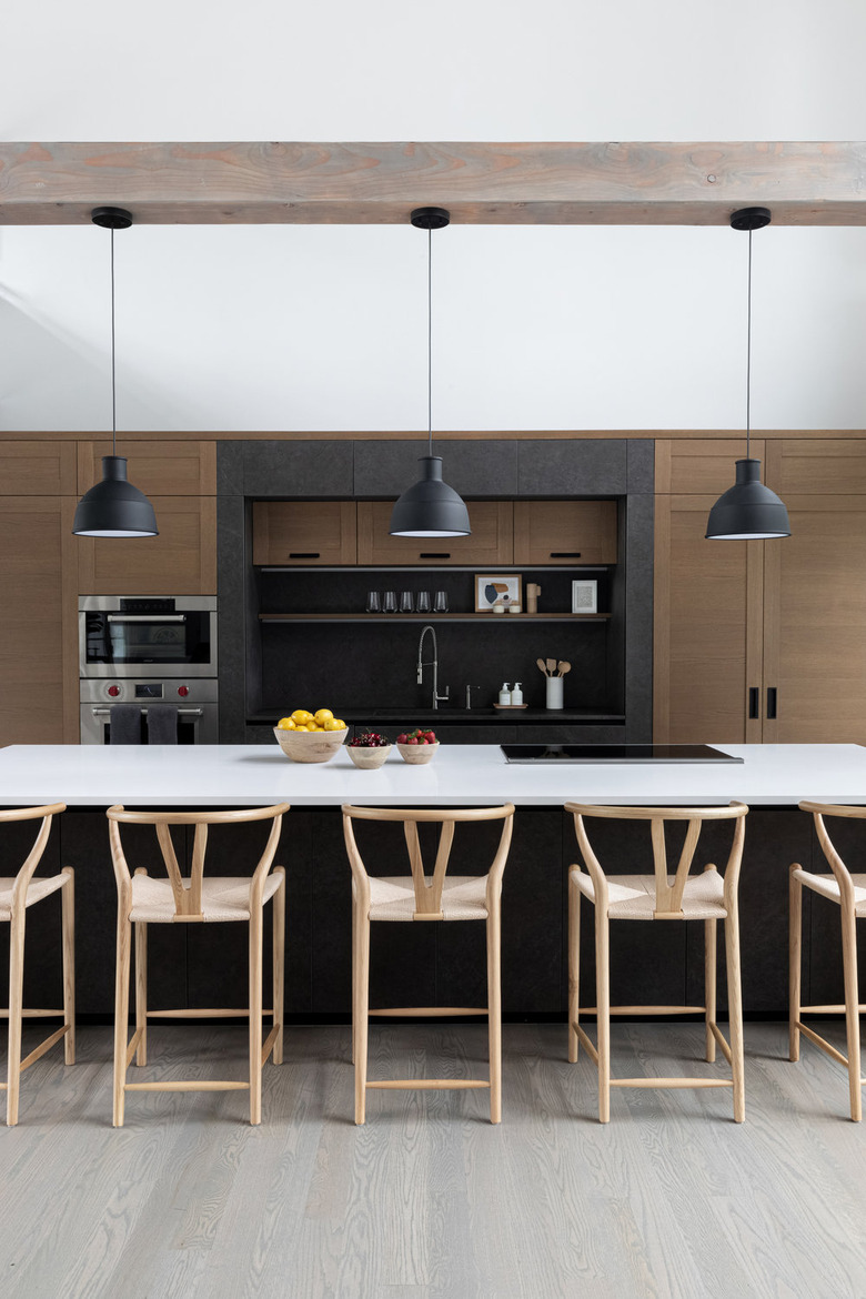 Modern kitchen design with an island stovetop designed by Chango & Co.