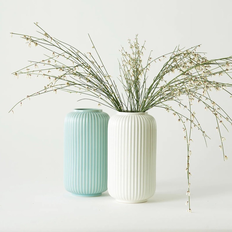 light blue vase and white vase, white vase has dried florals