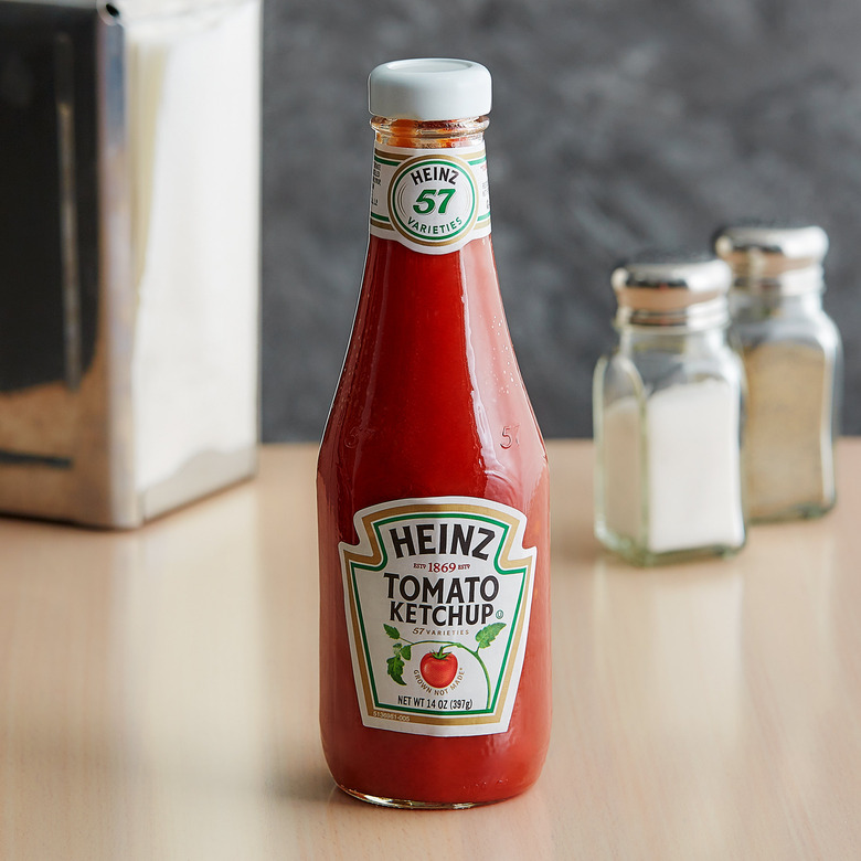 heinz ketchup bottle on wood table with salt and pepper