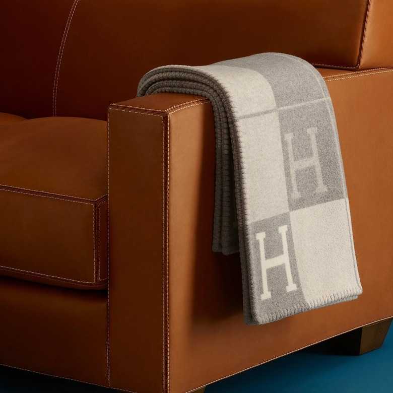 gray hermès throw draped on leather chair