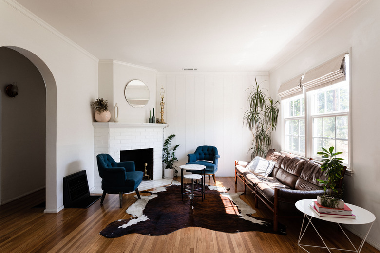 living room with cowhide rug on hardwood floor