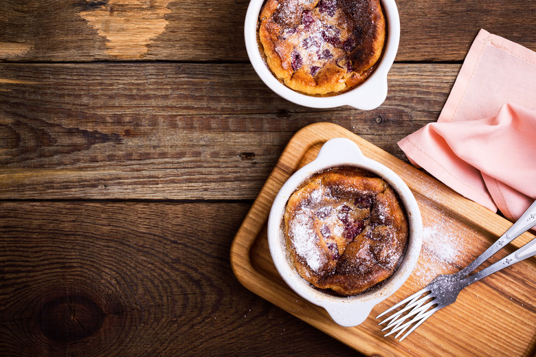 Classic french dessert cherry clafoutis in ceramic ramekins