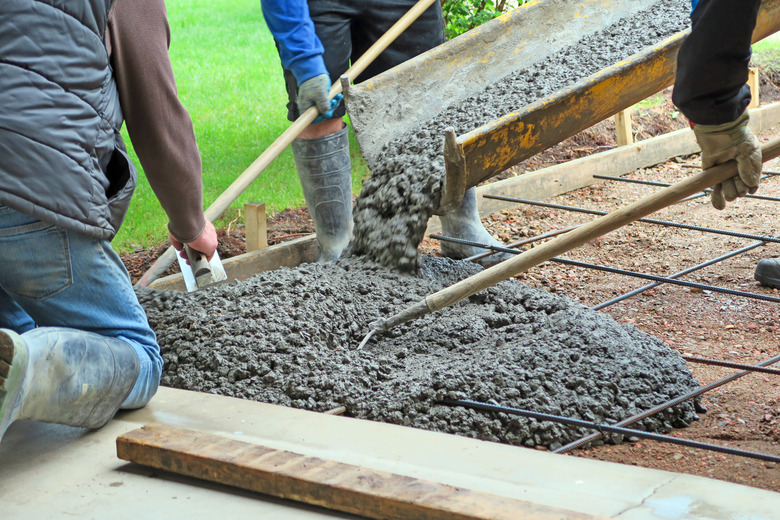 Make a concrete driveway- fresh cement from truck and workers