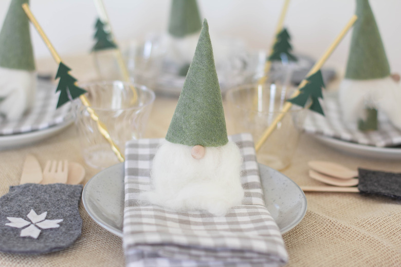 Christmas table decorated with Santa gnomes and mitten utensil holders