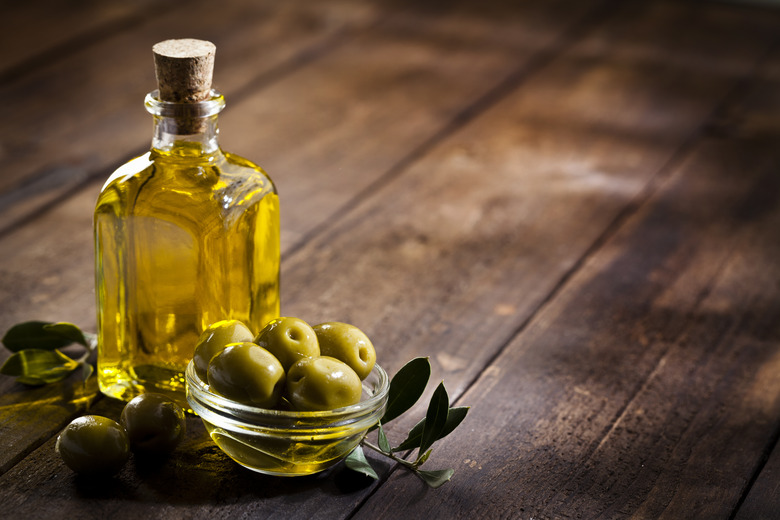 Olive oil and green olives. Copy space.