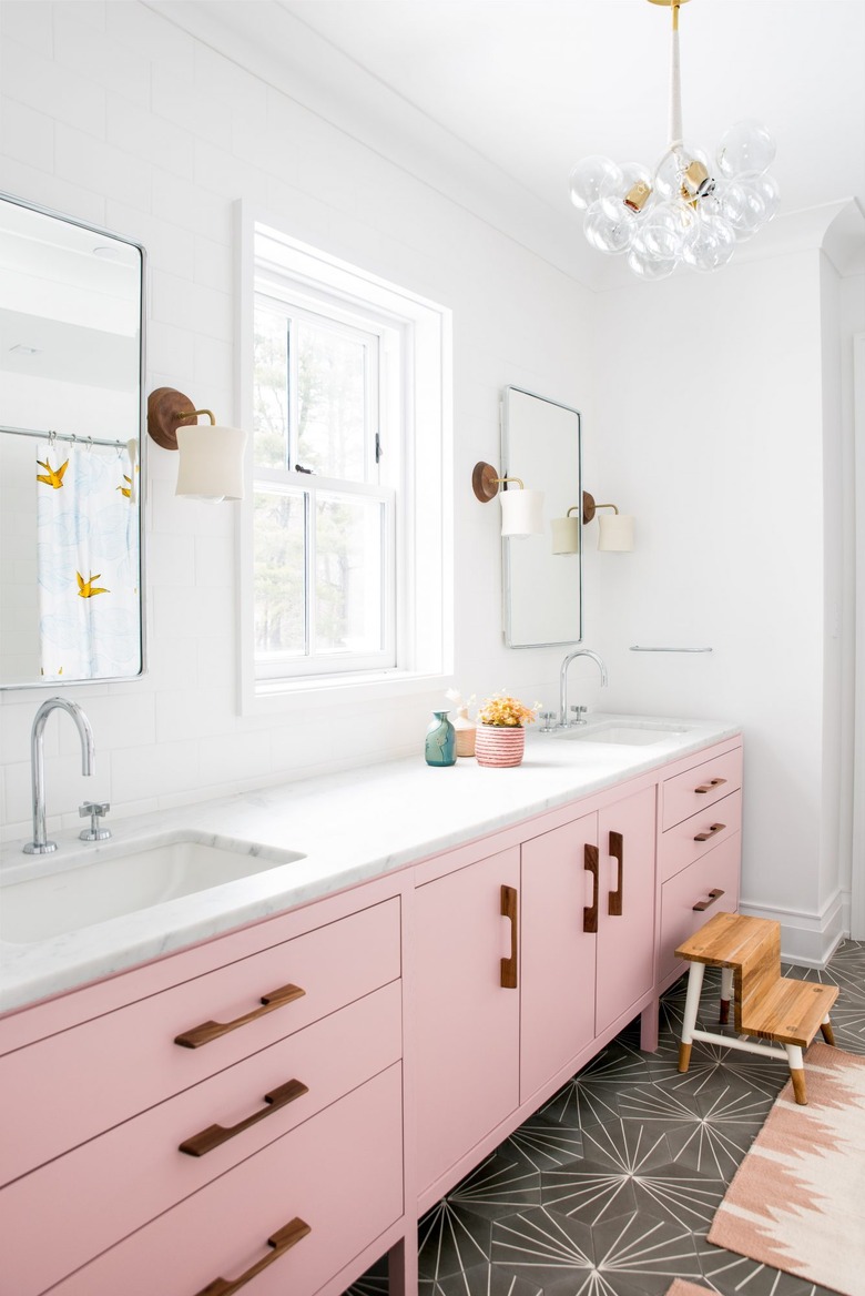 kids bathroom idea with pink vanity and cement floor tile