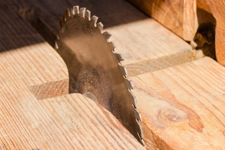 Circular saw blade for cutting wood closeup at selective focus