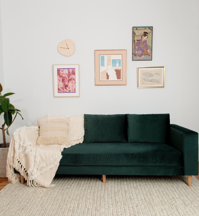 green velvet sofa with throw