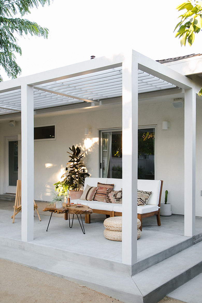 White contemporary pergola with matching contemporary furniture