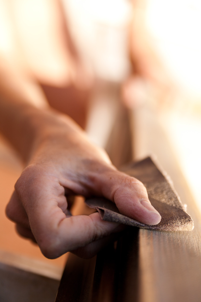 Hand of a woman sanding.