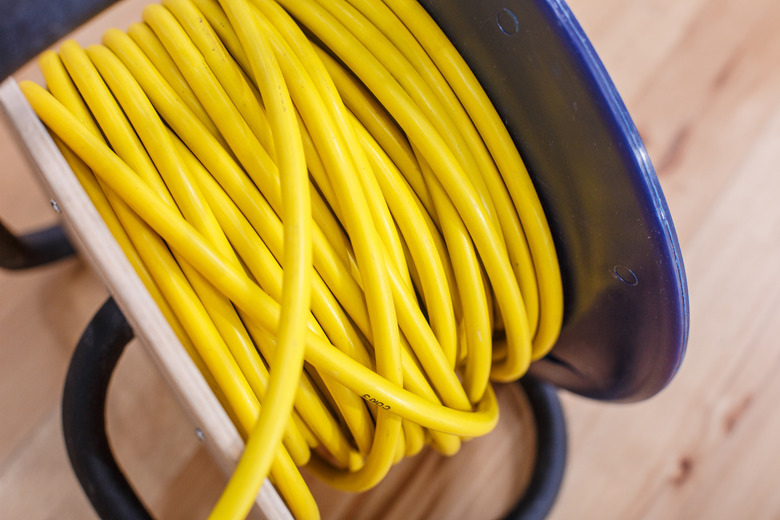 Yellow electric wire extension cord on the reel