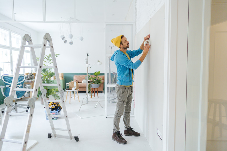 Installing drywall.