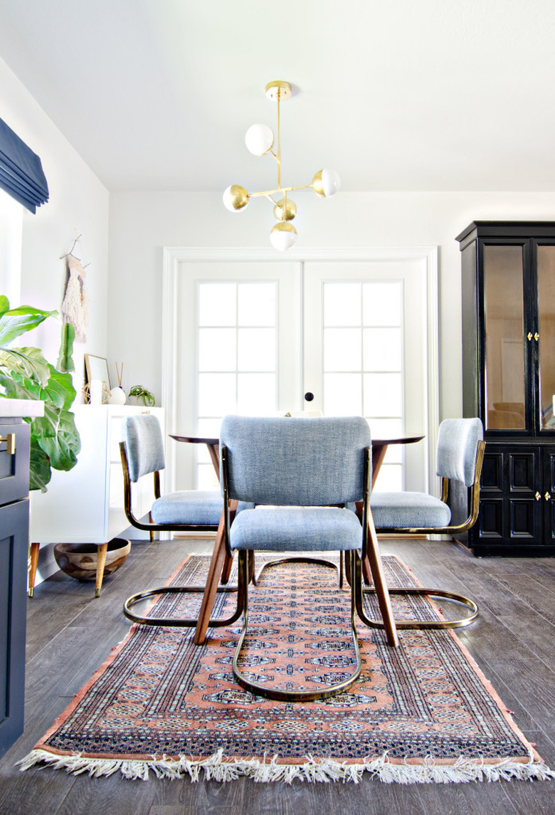 Midcentury dining room idea with curved chairs