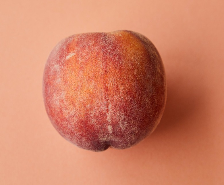 peach fruit on pink background