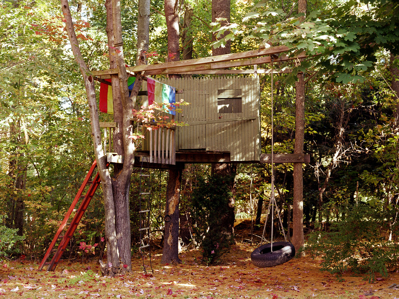 Treehouse in backyard with swing, autumn