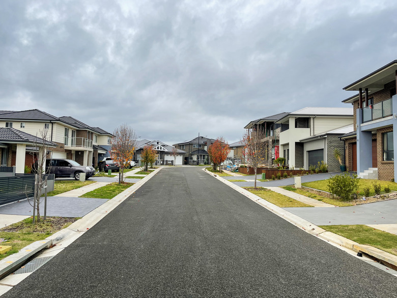 Houses along suburban street and overcast sky