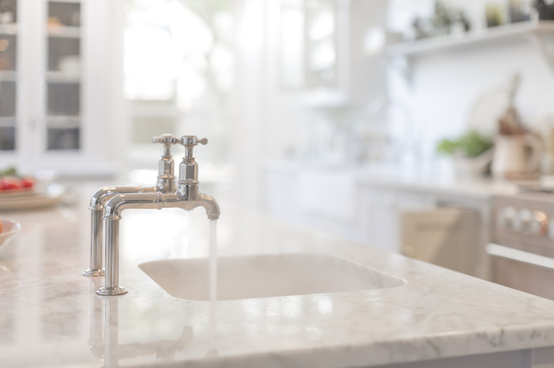 Water running from faucet in kitchen sink