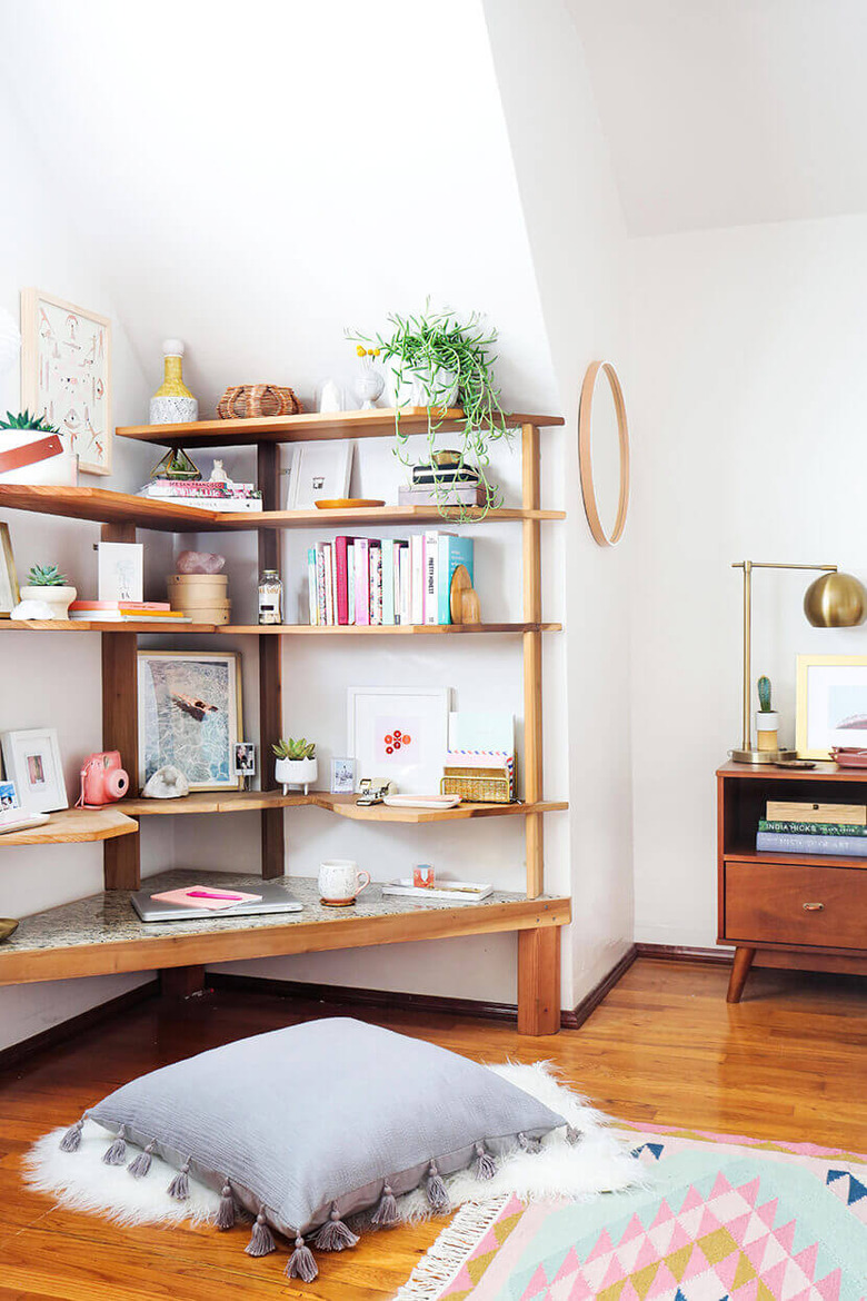 Bedroom shelving idea with corner unit filled with decorative items