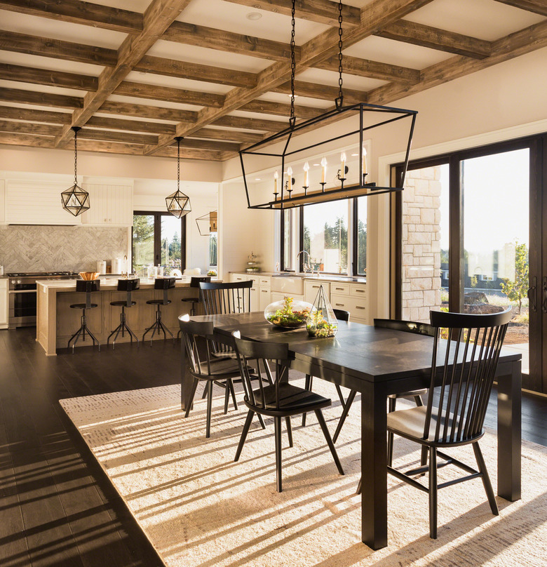 beautiful dining room and kitchen in new luxury home with island and pendant light fixtures