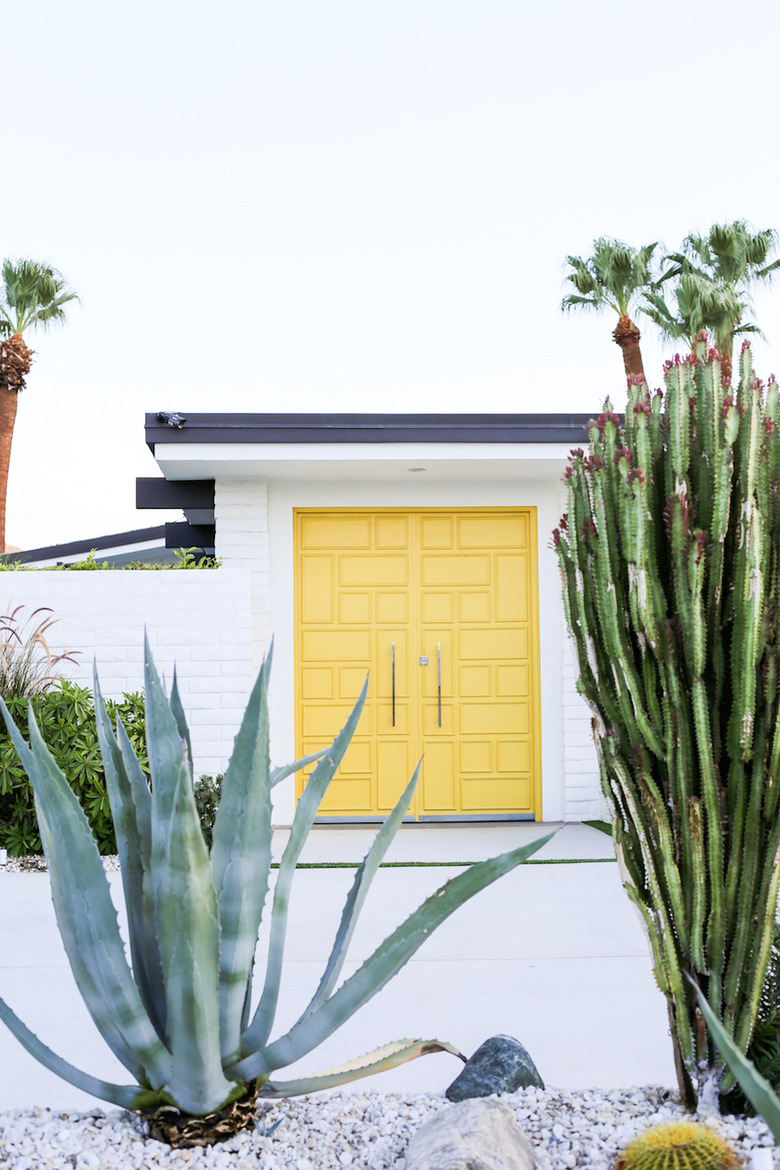 Yellow midcentury modern front door with square shapes and cacti