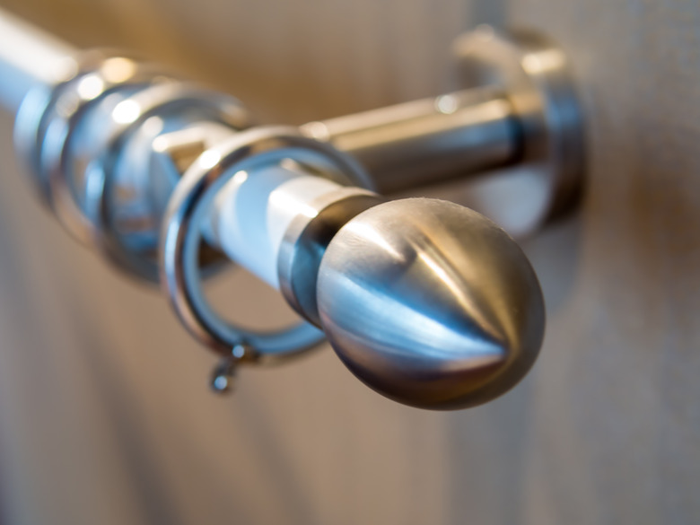 Stainless curtain rod on the wooden wall