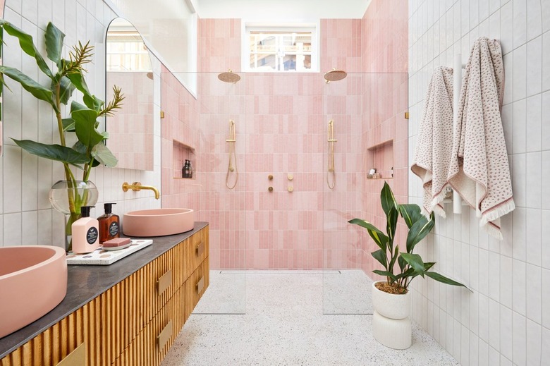 Bright bathroom with pink walk-in shower tiles