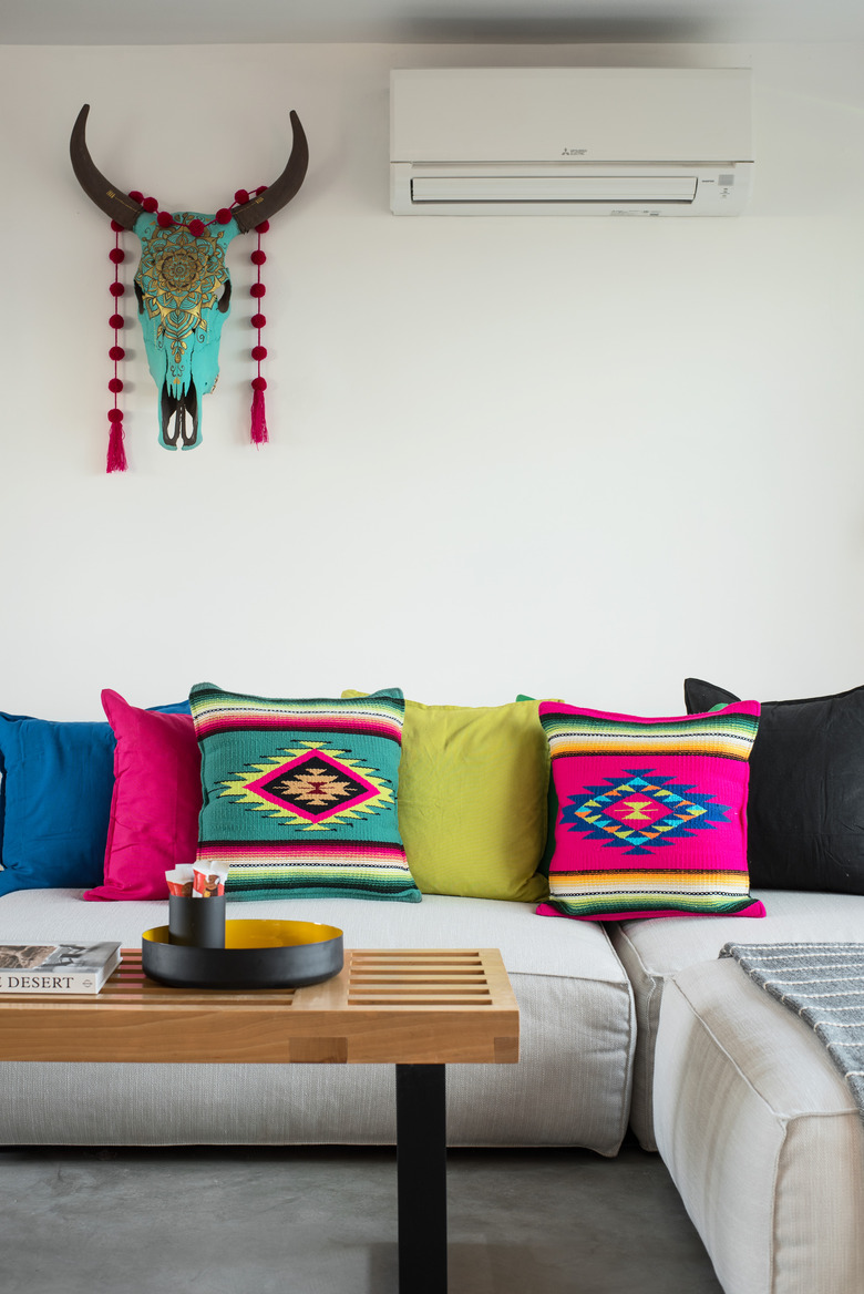 secondary colors in living room with vibrant pillows