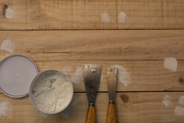 Putty knife and the wooden floor.