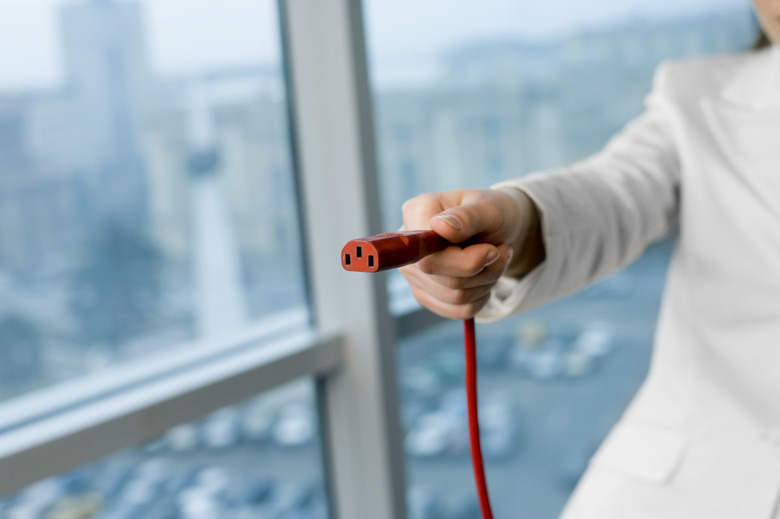 Hand holding power cord