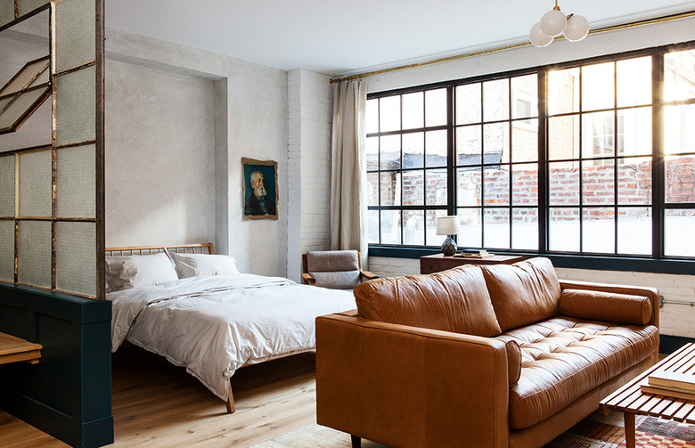 neutral bedroom with leather sofa and textured walls