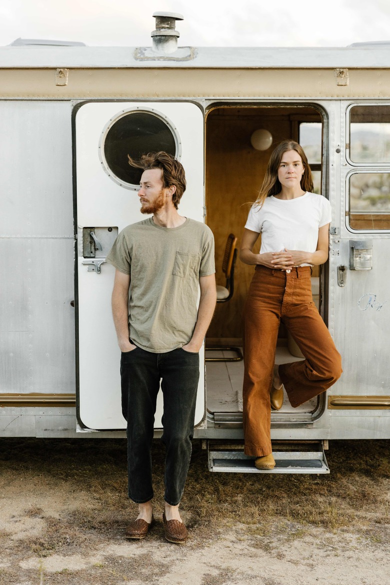 Kelly Brown and Bryce Ehrecke outside of their trailer, Dixie.