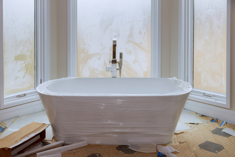 Master bath in new construction home with white tub