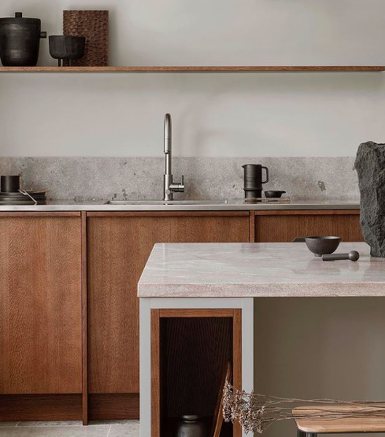 dark wood cabinets with steel countertop and limestone counter at island