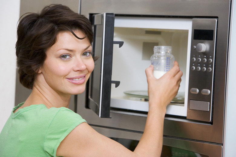 Woman microwaving bottle