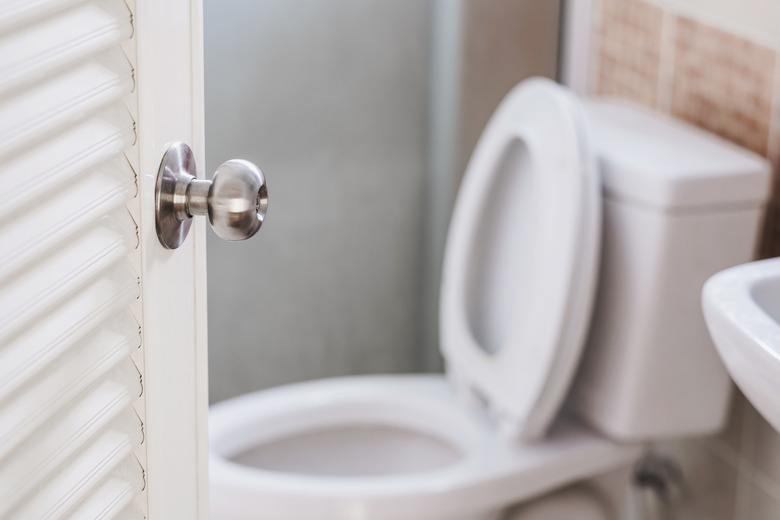 Close-up, Toilet door, with stationery, selective focus on door knob