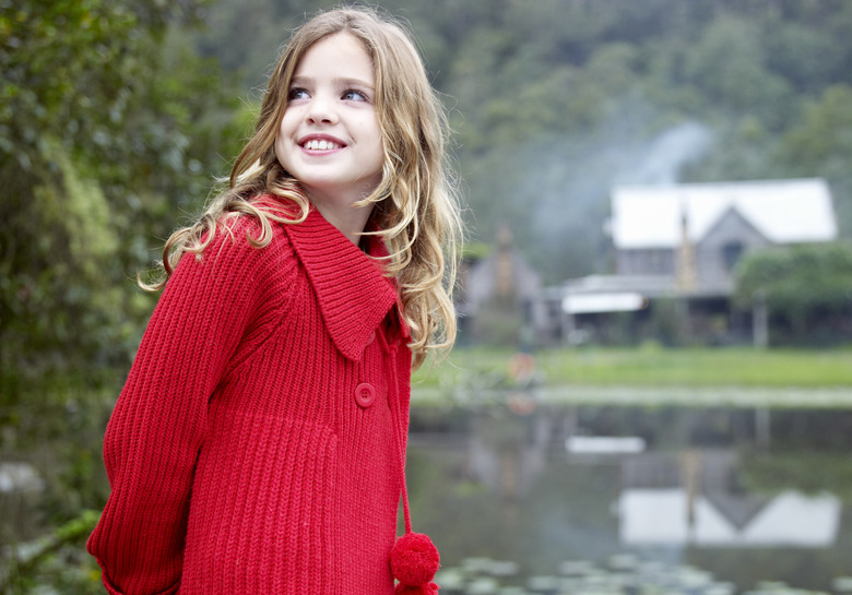 Girl outdoors in front of country home