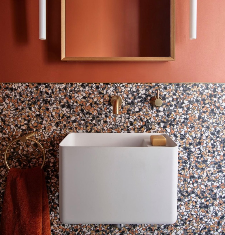 terrazzo backlash with salmon walls and gold hardware